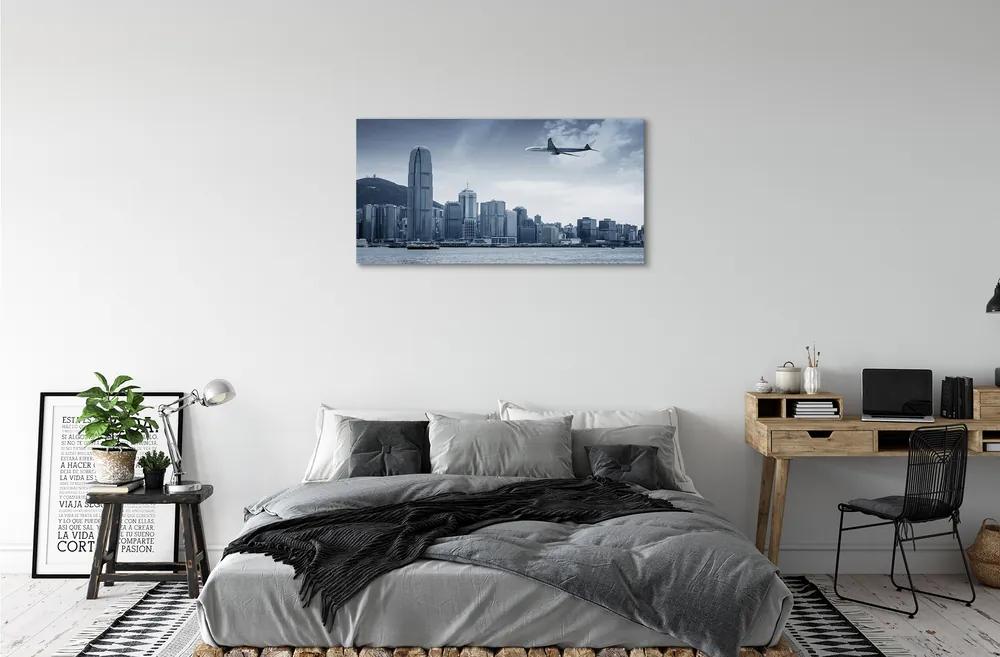 Obraz canvas Lietadiel mraky město 140x70 cm