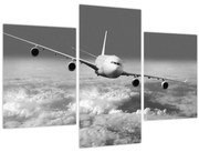 Obraz - Lietadlo v oblakoch, čiernobiele (90x60 cm)