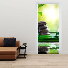 Fototapeta na dvere - Masážne kamene a orchidea na vode (95x205cm)