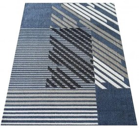 Dizajnový koberec modrej farby s pruhmi
