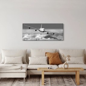 Obraz - Lietadlo v oblakoch, čiernobiele (120x50 cm)