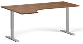 Rohový výškovo nastaviteľný stôl, 180x120 cm, 2 motory, L/P, sivá podnož, orech