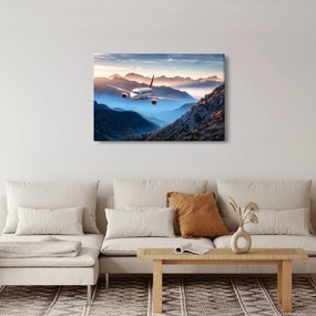 Obraz - Lietadlo nad vrcholmi hôr (90x60 cm)