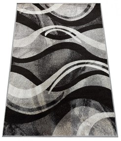 Originálny koberec s abstraktným vzorom v šedej farbe