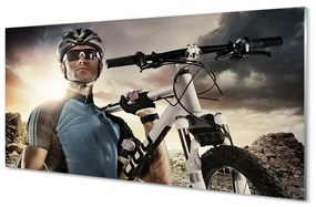 Obraz na skle Cyklista na bicykli mraky 125x50 cm
