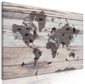 Obraz mapa sveta so symbolickými zvieratami  na drevenom podklade