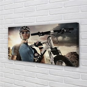 Obraz canvas Cyklista na bicykli mraky 140x70 cm