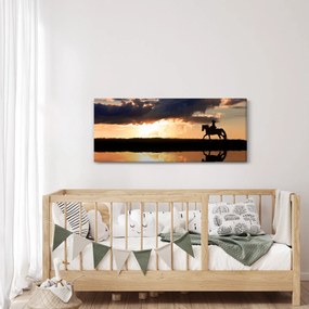Obraz - Jazdec na koni pri západe slnka (120x50 cm)