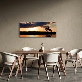 Obraz - Jazdec na koni pri západe slnka (120x50 cm)