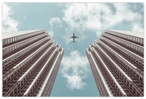 Obraz lietadla medzi budovami (90x60 cm)