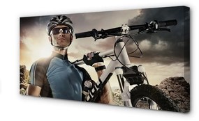 Obraz canvas Cyklista na bicykli mraky 140x70 cm