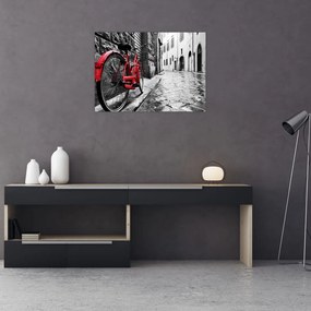 Sklenený obraz červeného kolesa na dláždenej ulici (70x50 cm)