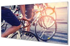 Obraz na skle cyklisti ľudí 100x50 cm