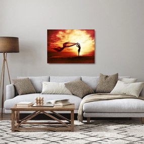 Sklenený obraz - Silueta ženy v západu slnka (70x50 cm)
