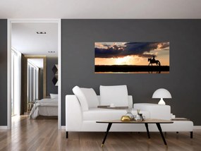 Obraz - Jazdec na koni pri západe slnka (120x50 cm)