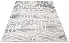 Svetlý dizajnový koberec s geometrickým vzorom