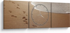 Obraz - stopy v piesku a more (s hodinami) (90x30 cm)
