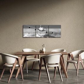 Obraz - Lietadlo v oblakoch, čiernobiele (s hodinami) (90x30 cm)