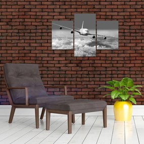 Obraz - Lietadlo v oblakoch, čiernobiele (90x60 cm)