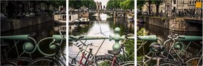 Obraz bicykla v meste (s hodinami) (90x30 cm)