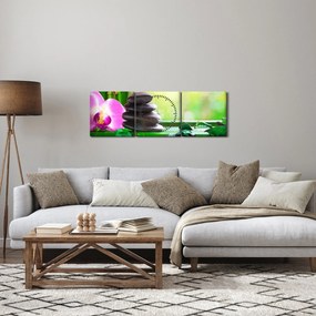 Obraz masážnych kameňov a orchidey na vode (s hodinami) (90x30 cm)