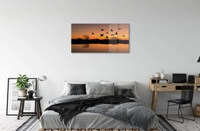 Sklenený obraz Lietajúce vtáky sunset 140x70 cm