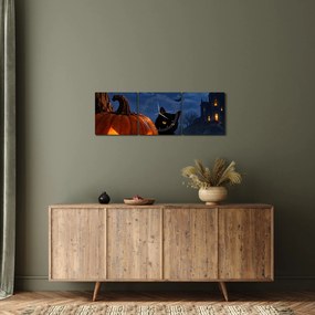 Obraz - Čierna mačka pri svietiacej tekvici na Halloween (s hodinami) (90x30 cm)