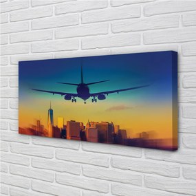 Obraz canvas Veľkomesto oblačnosti lietadlo západ 125x50 cm