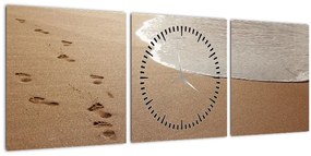 Obraz - stopy v piesku a more (s hodinami) (90x30 cm)