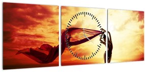 Obraz - Silueta ženy v západu slnka (s hodinami) (90x30 cm)