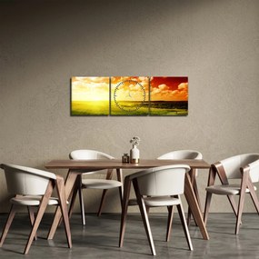 Obraz lúky so žiariacim slnkom (s hodinami) (90x30 cm)