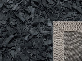 Kožený koberec 80 x 150 cm čierny MUT Beliani