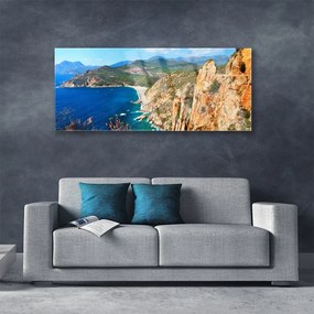 Obraz plexi Útes pobrežie more hory 125x50 cm
