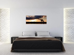 Obraz - Jazdec na koni pri západe slnka (120x50 cm)