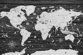 Obraz na korku historická mapa sveta na drevenom pozadí v čiernobielom prevedení